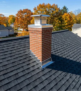 After: new red brick chimney with a stainless cap and metal flashing